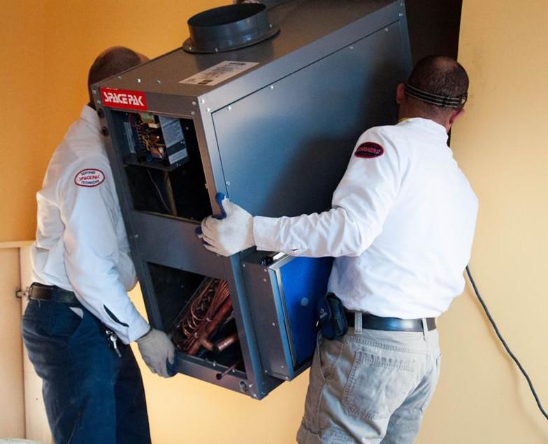 Two certified SpacePak contractors installing a SpacePak air unit