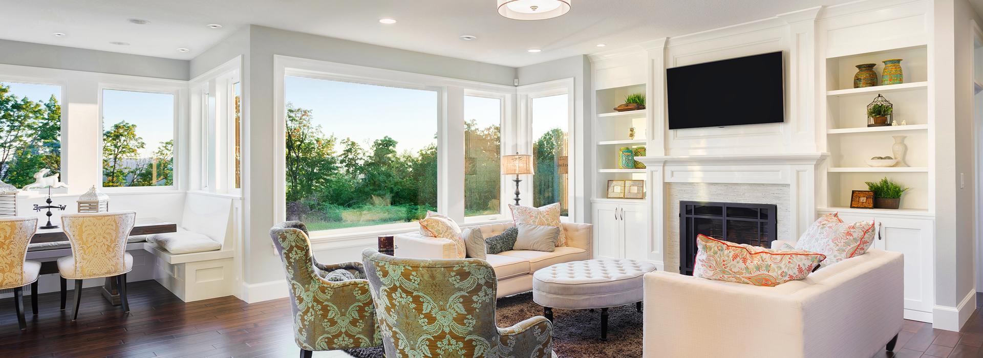 Living room with bright furniture and SpacePak outlets hidden in the ceiling 